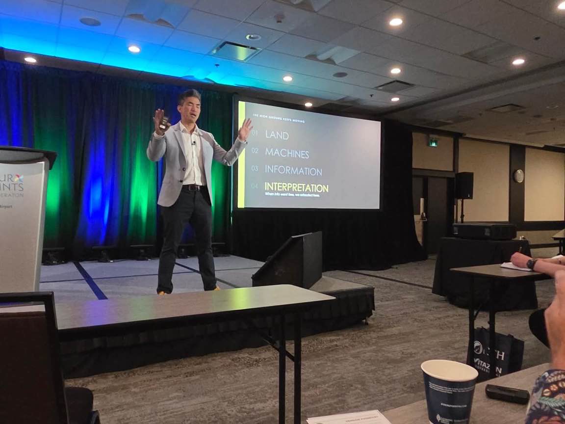 Laurence Tham mid-keynote at AFC Toronto, May 2026.